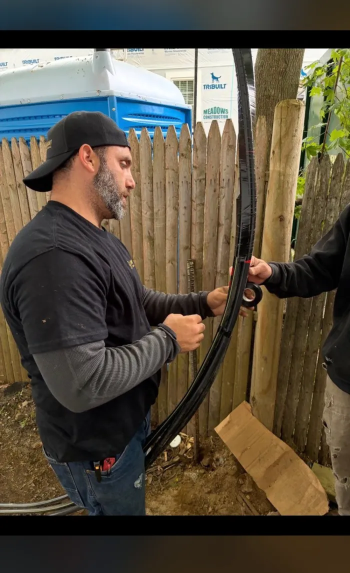 AmpSmart electrician pulling cable on a job site